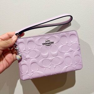 Coach Corner Zip Wristlet In Signature
Leather With Heart Charm